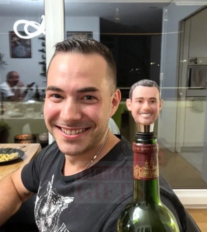Man with a custom bobble head wine stopper