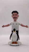 Smiling man bobble head with penguin
