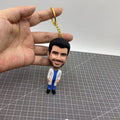 Bobble head keychain with smiling face figurine
