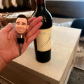 Hand holding custom bobble head wine stopper