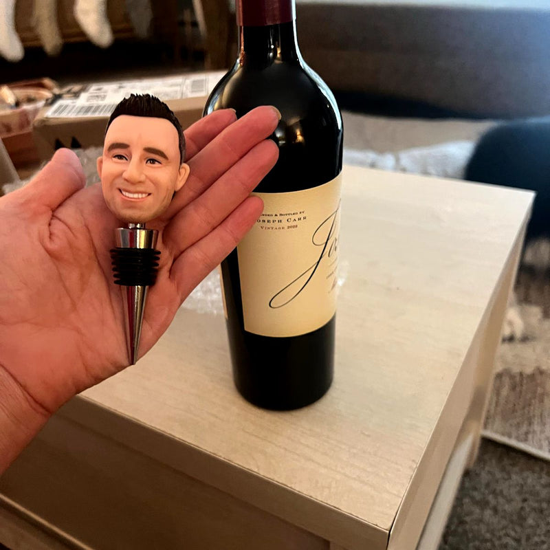 Hand holding custom bobble head wine stopper